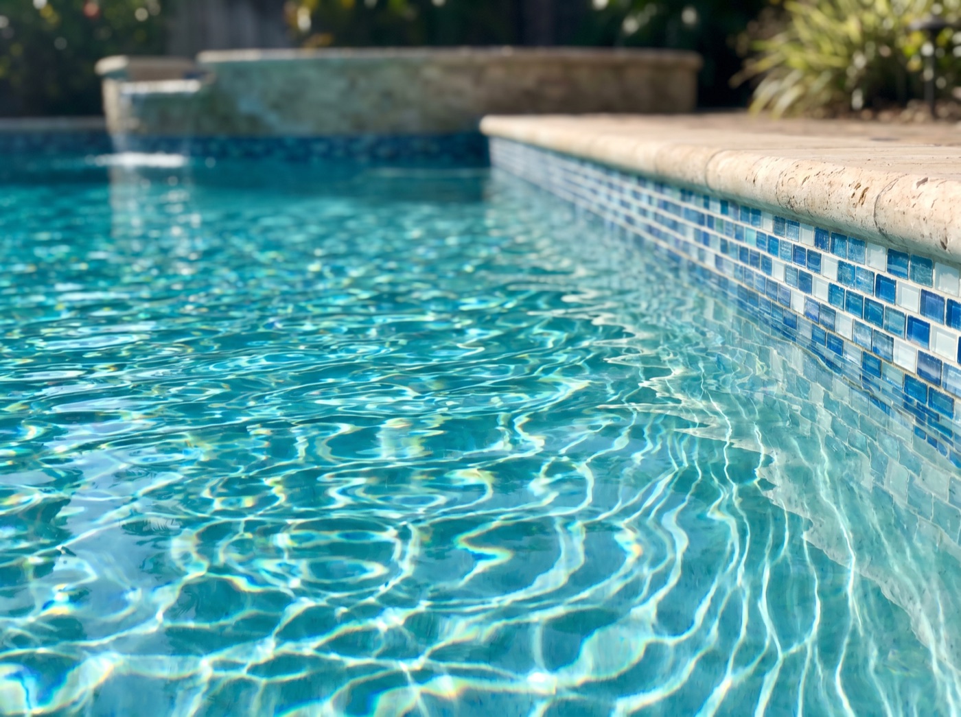 A clean residential pool with clear blue water