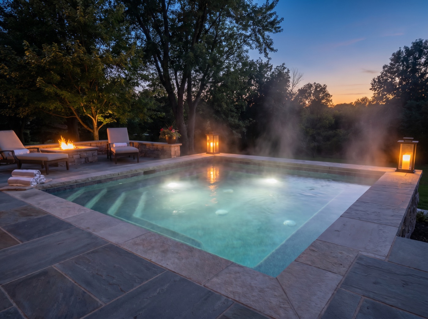 A warm backyard spa at dusk with clear water